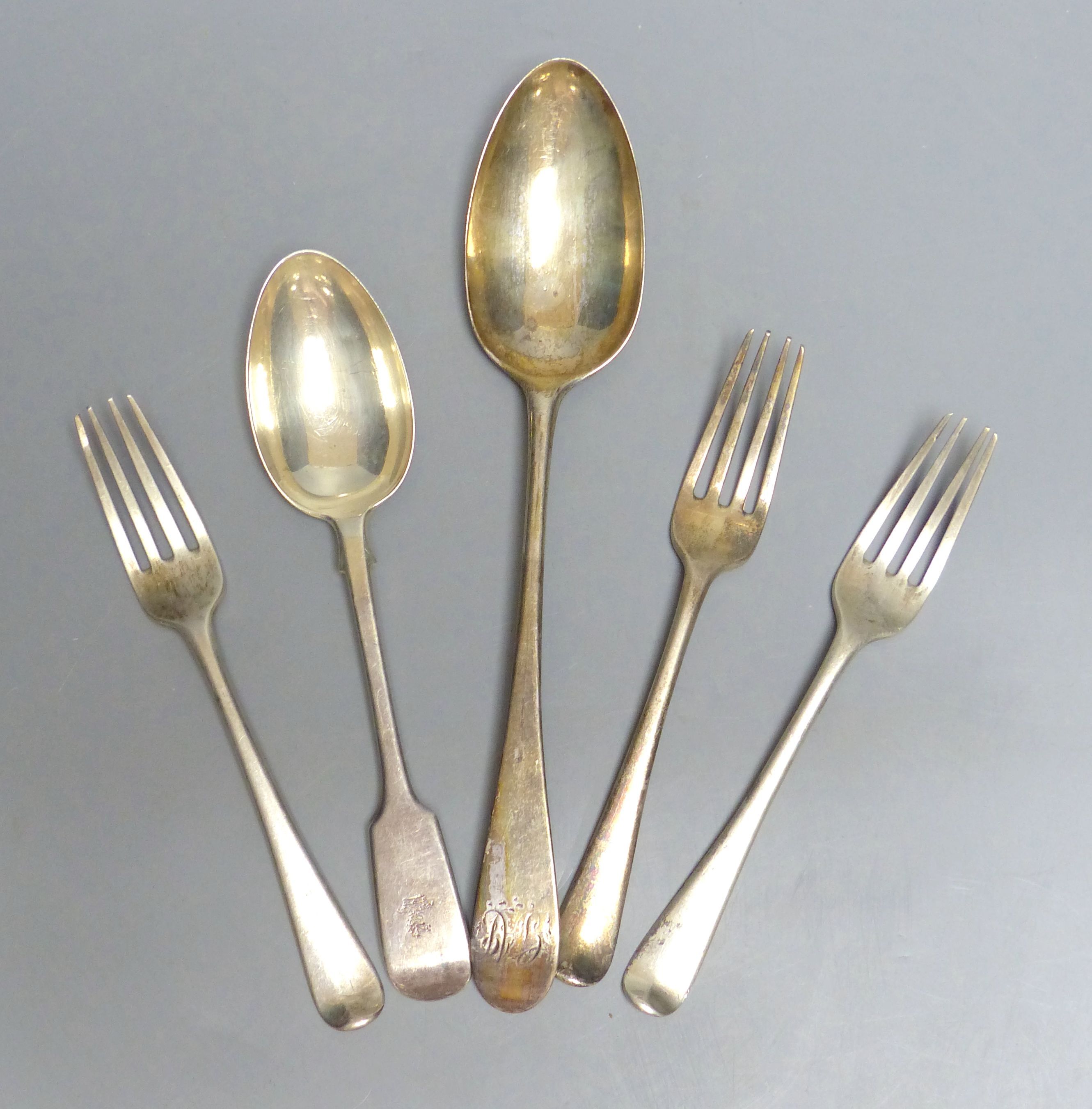 A Georgian Newcastle silver table spoon, three George III silver dessert forks and a later dessert spoons, 7oz.